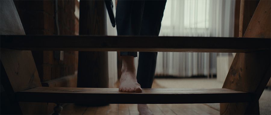 Mezzanine scene - close up of a foot on a set of stairs