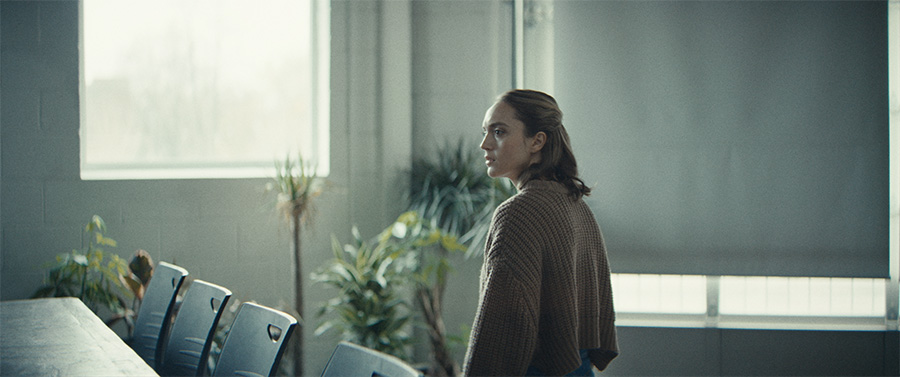 A woman looks across a table