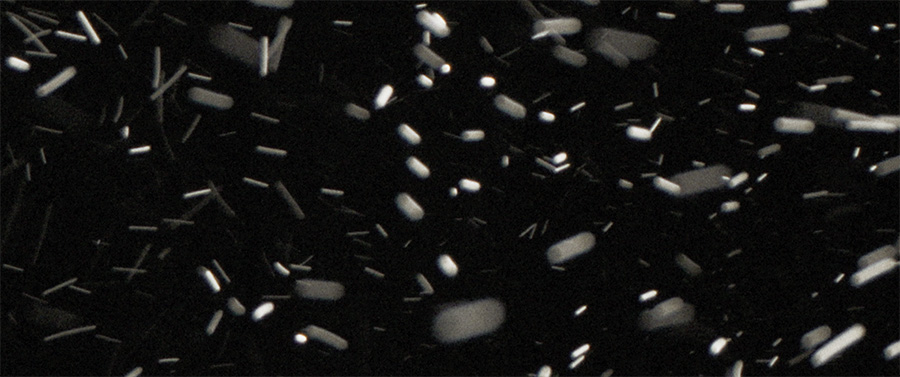 black background with white cylindrical flecks