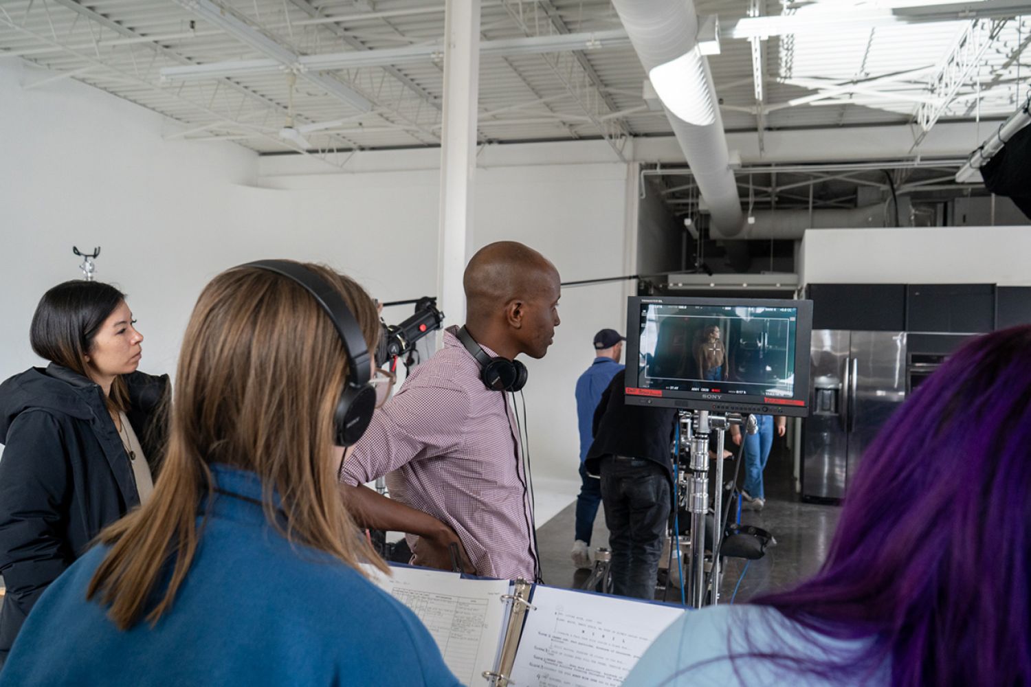 The director views a filmed scene on the screen