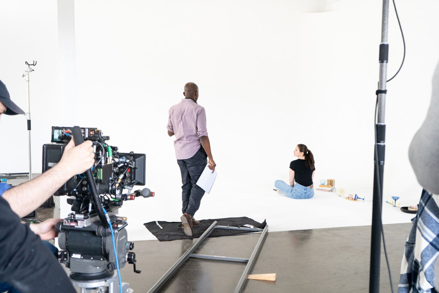 The director speaks to an actress on the set for NIHIL