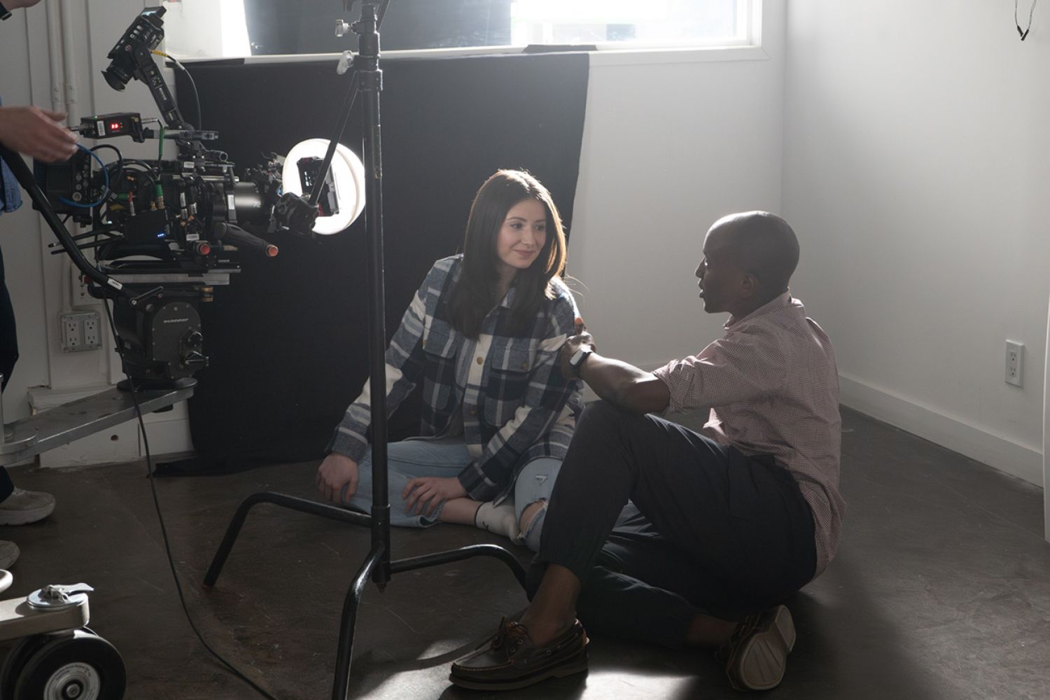 Director Eden talks to a woman